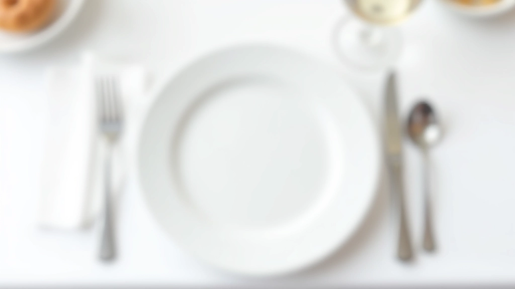 Close-up view of formal place setting showing proper positioning of silverware, plates, and glassware on white tablecloth